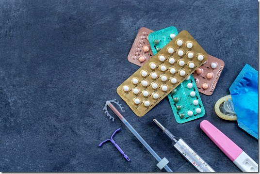 Choosing method of contraception : Birth control pills, an injection syringe, condom, IUD-method, on grey