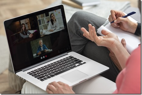 older-couple-home-couch-having-video-call-laptop