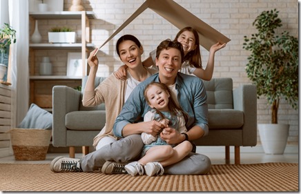 Mother, father and children girls in the room with a symbol of roof. Concept of housing for young family. 