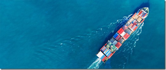 Aerial view of cargo ship with contrail in the ocean sea ship carrying container and running from container international port smart freight shipping by ship service