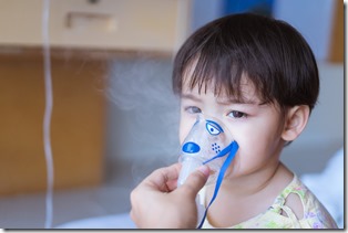 Little Asian boy under anesthesia with an oxygen mask in hospital. 