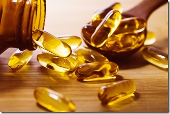 Close up the vitamin D and Omega 3 fish oil capsules supplement on wooden plate for good brain , heart and health eating benefit