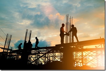 Silhouette of engineer and construction team working at site over blurred background sunset pastel for industry background with Light fair.