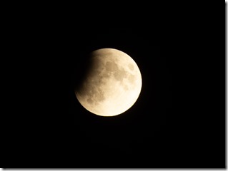 Progressing partial lunar eclipse with visible lunar seas and craters on moon surface