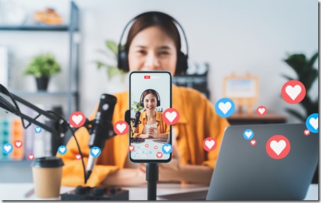 \Vlogger live streaming podcast review on social media, Young Asian woman use microphones wear headphones with laptop record video. Content creator concept.