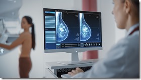 Computer Screen in Hospital Radiology Room: Beautiful Multiethnic Adult Woman Standing Topless Undergoing Mammography Screening Procedure. Screen Showing the Mammogram Scans of Dense Breast Tissues.