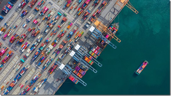 Aerial view cargo ship terminal, Unloading crane of cargo ship terminal, Aerial view industrial port with containers and container ship.