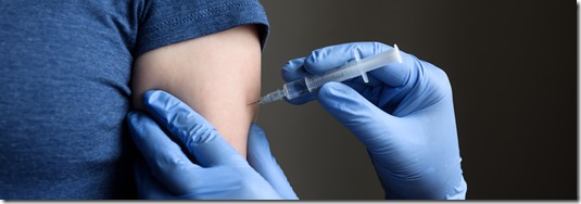 COVID-19 vaccine shot, doctor in gloves holds syringe and makes jab to woman patient in clinic. Prevention of coronavirus or influenza. Concept of injection from corona virus and flu, and treatment.