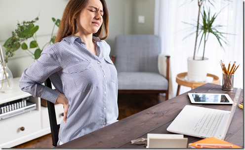 Freelancer young woman suffering with back pain