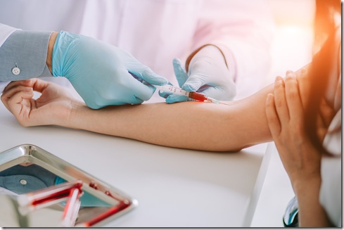 Close up Hand of nurse, doctor or Medical technologist in blue gloves taking blood sample from a patient in the hospital.