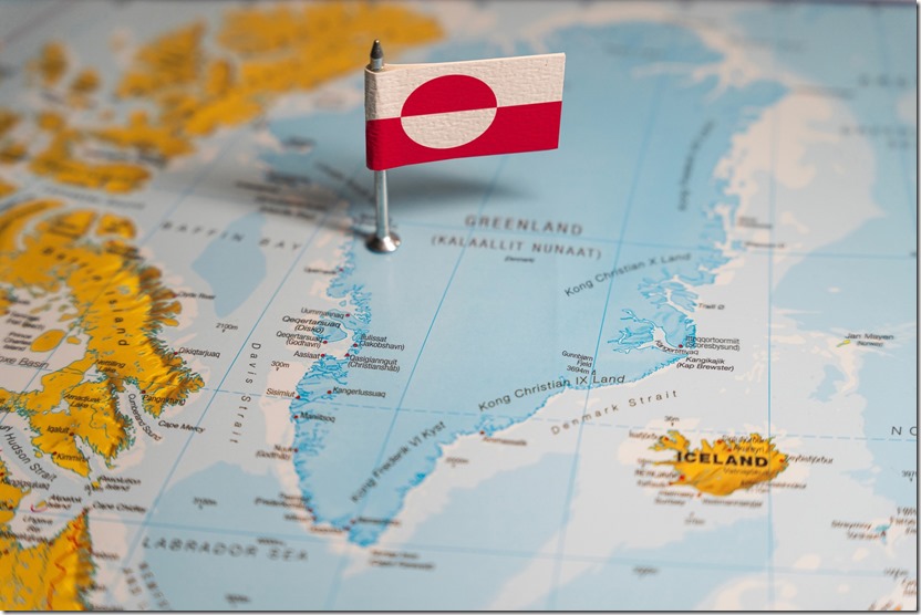 The Greenlandic flag pinpointed on a map of Greenland, representing national identity and territorial sovereignty on Arctic region