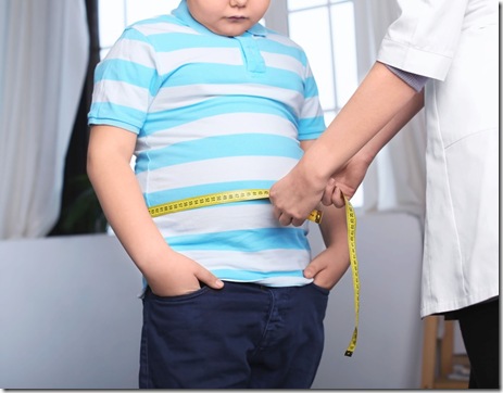Doctor measuring overweight boy in clinic
